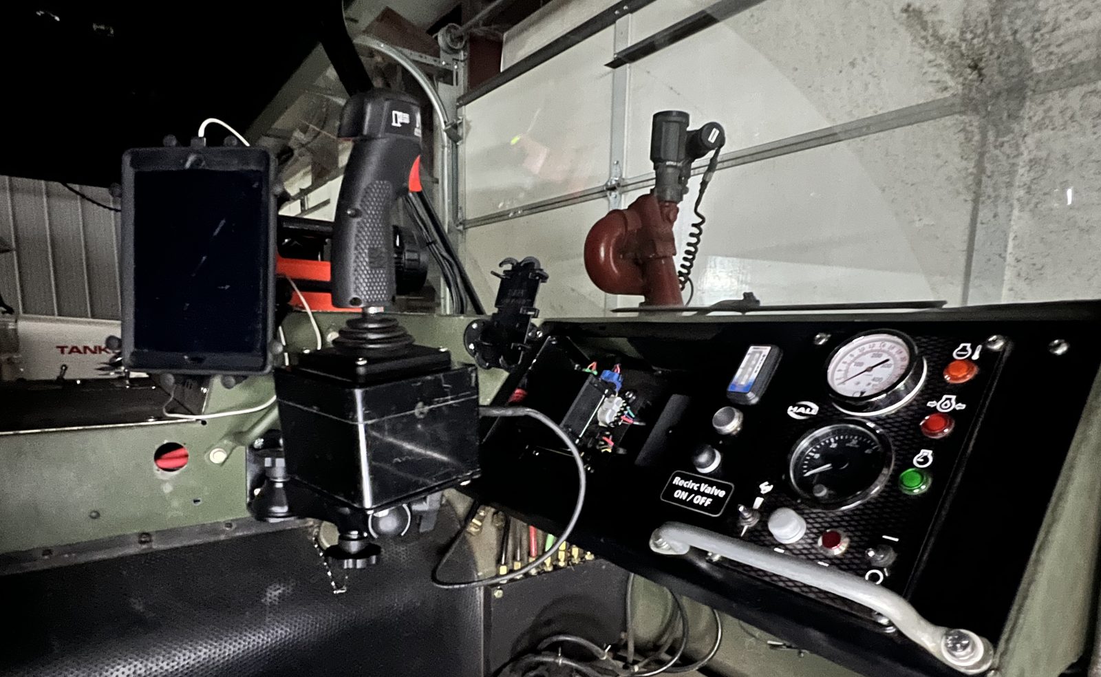 Turret joystick, display mount and pump panel built into a truck cab