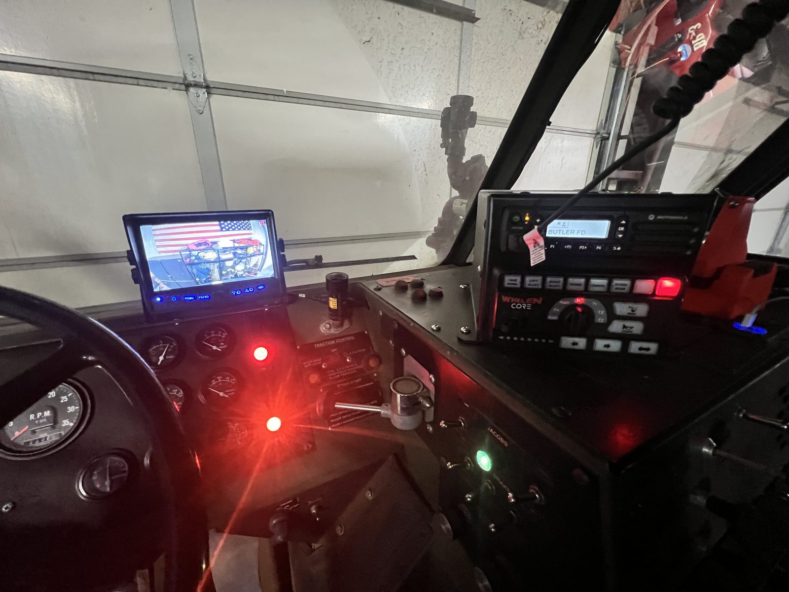 Truck cab powered up with camera monitor, radio and backlit switch panel