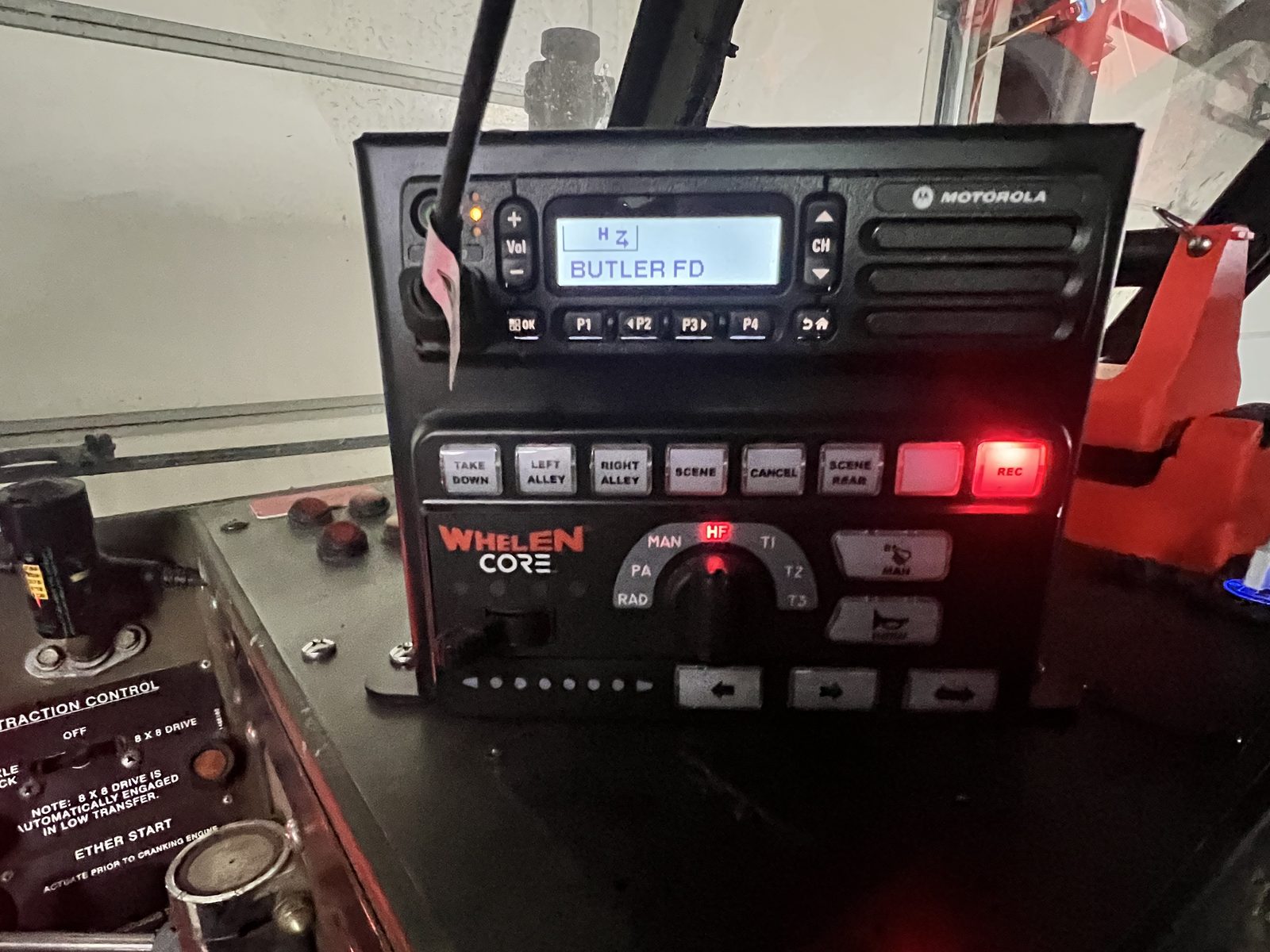 Motorola radio and Whelen CORE controller with custom-labeled scene lighting buttons