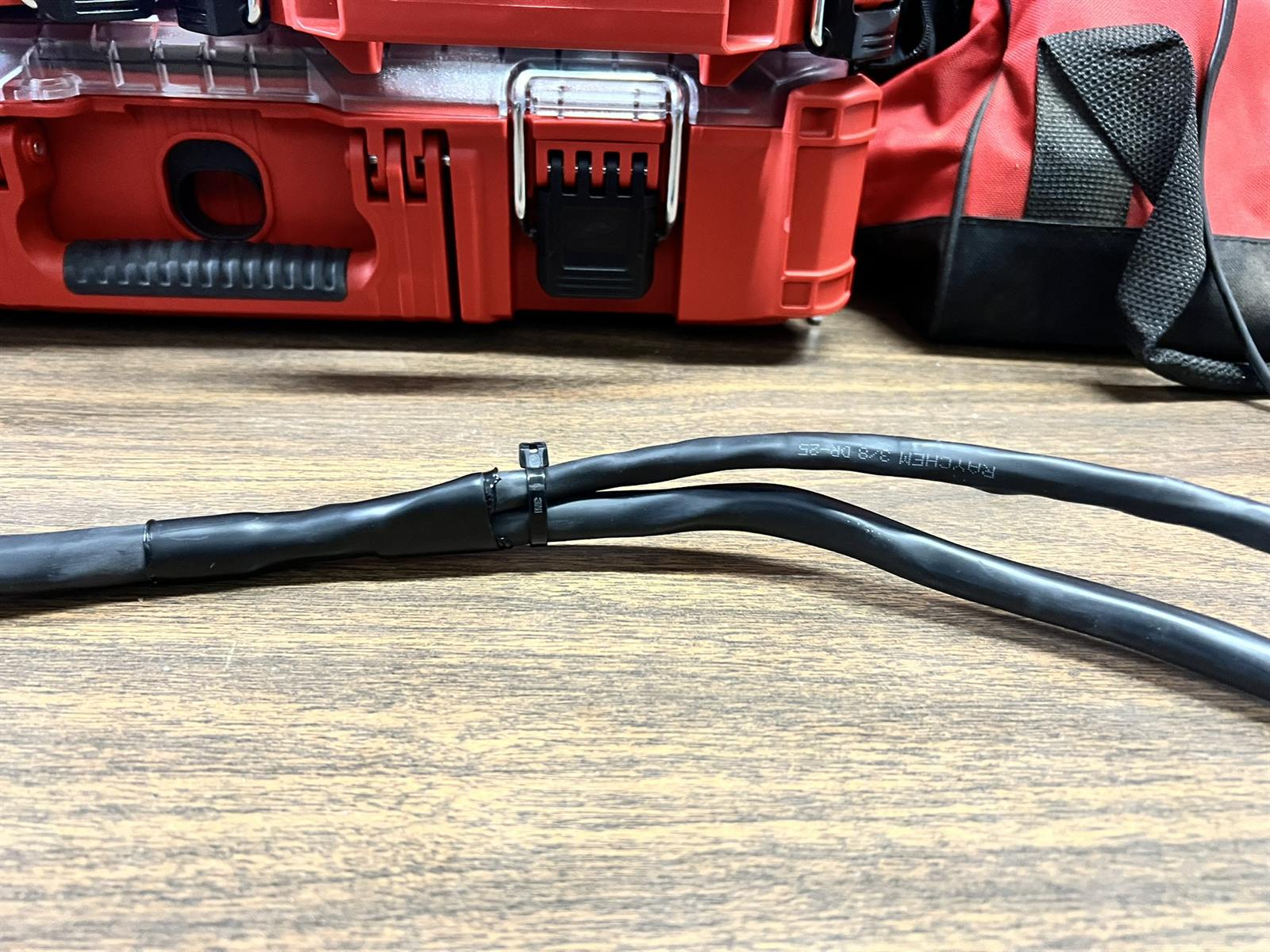 Heat-shrink and loom detail on a finished cable run