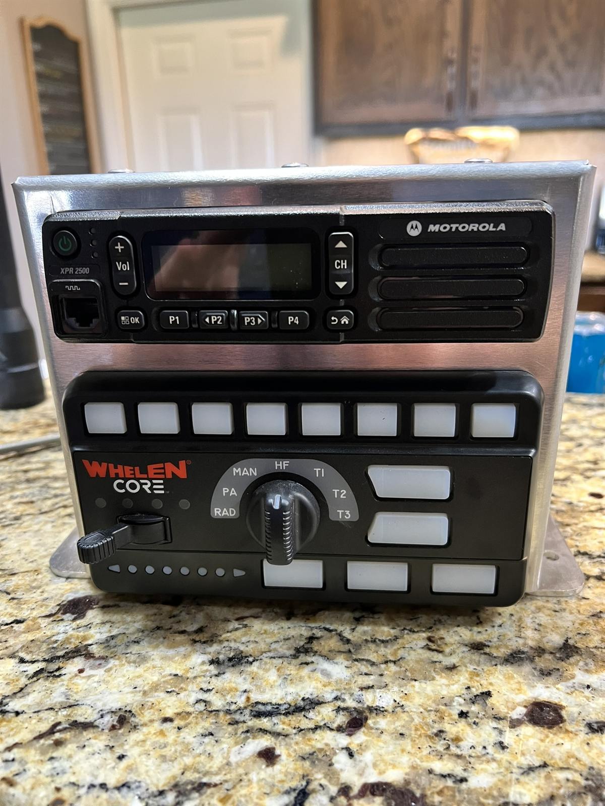 Whelen CORE siren and Motorola radio in a brushed console